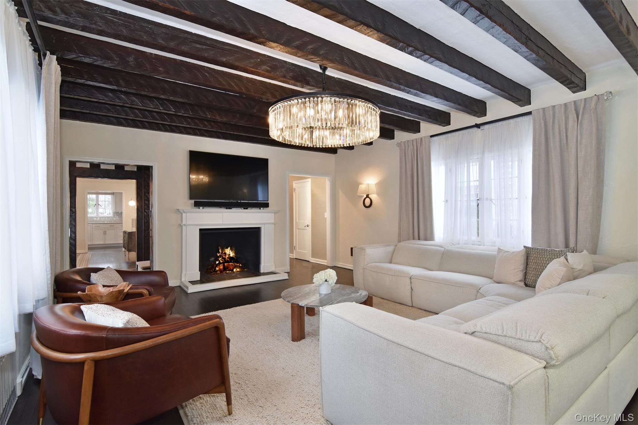 30 Locust Lane Bronxville, NY 10708 - Photo 3 of 28 a living room with furniture a fireplace and a large window