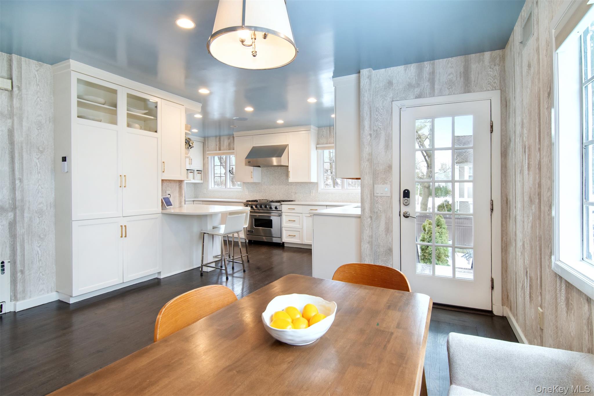 30 Locust Lane Bronxville, NY 10708 - Photo 10 of 28 a kitchen with stainless steel appliances a dining table chairs and a refrigerator