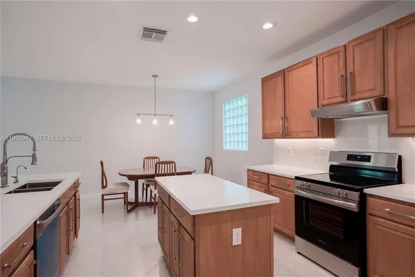 a kitchen that has a sink and a stove