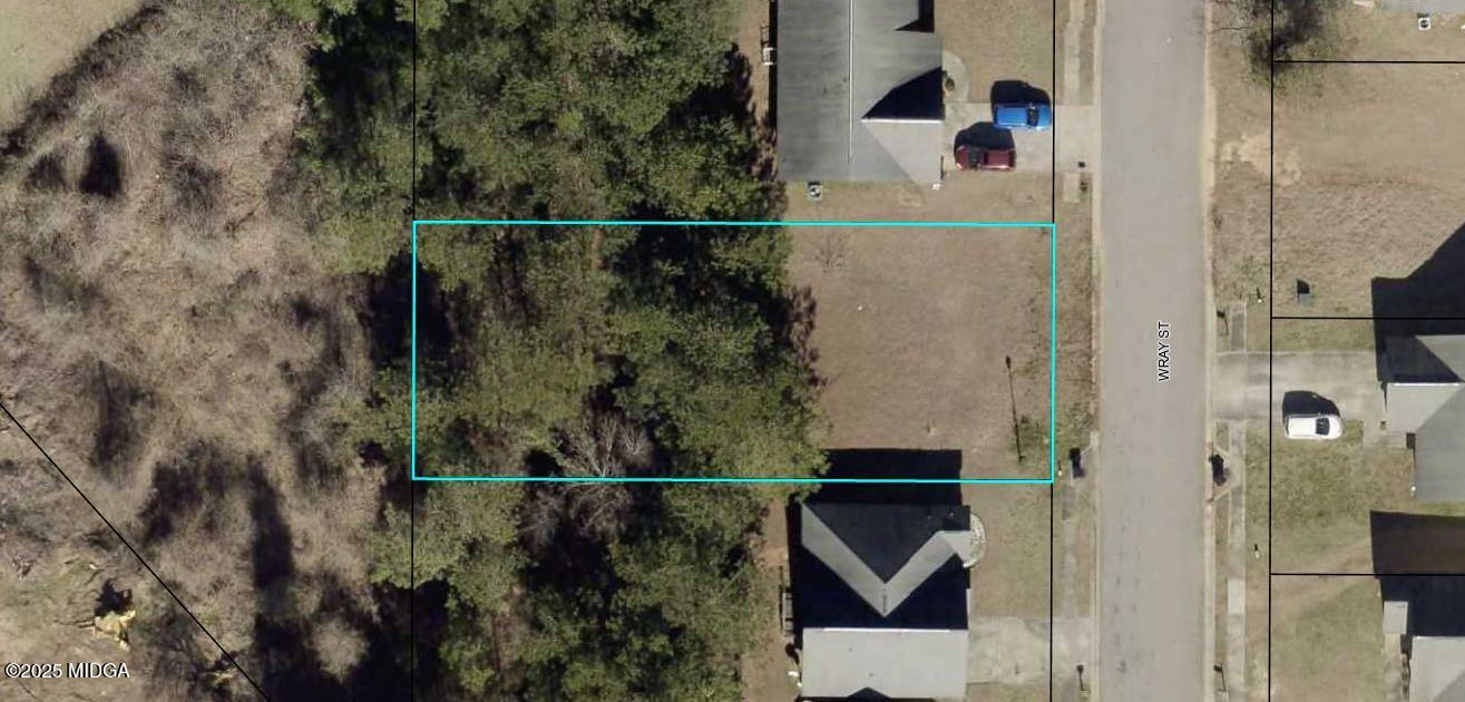 an aerial view of a house with a yard