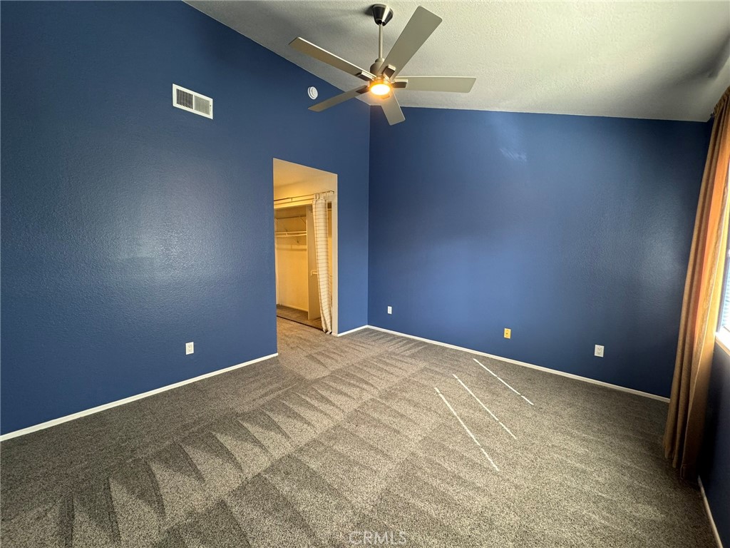 1254 Sand Creek Road San Dimas, CA 91773 - Photo 16 of 26 a view of an empty room with a ceiling fan and window