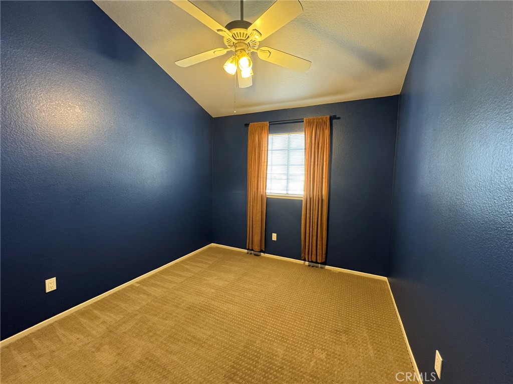 1254 Sand Creek Road San Dimas, CA 91773 - Photo 20 of 26 a bedroom with a bed and a chandelier