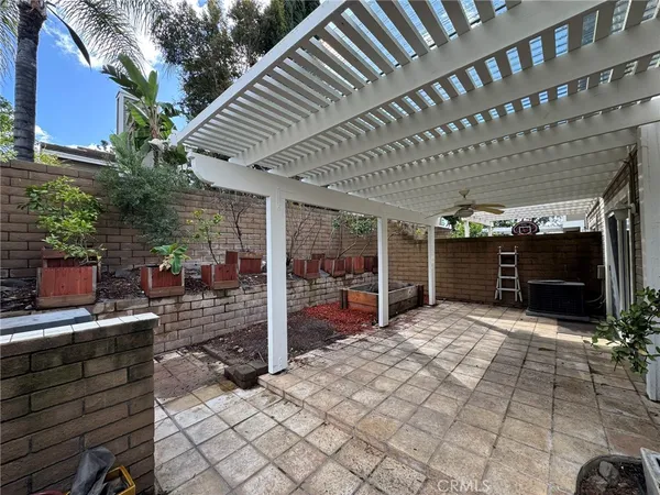 a view of a porch with furniture and next to a yard