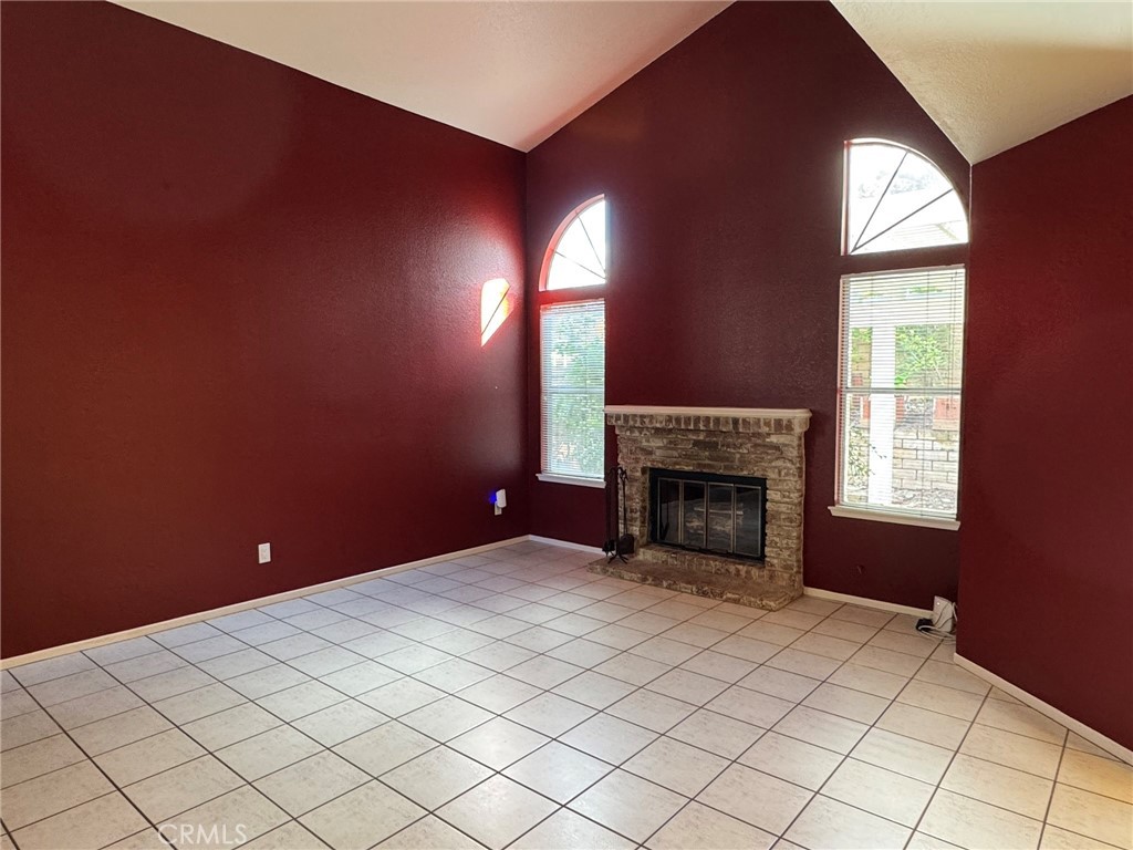 1254 Sand Creek Road San Dimas, CA 91773 - Photo 4 of 26 a view of an empty room with a fireplace and window