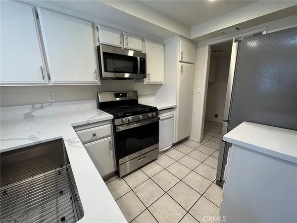 a kitchen with a sink and a stove top oven