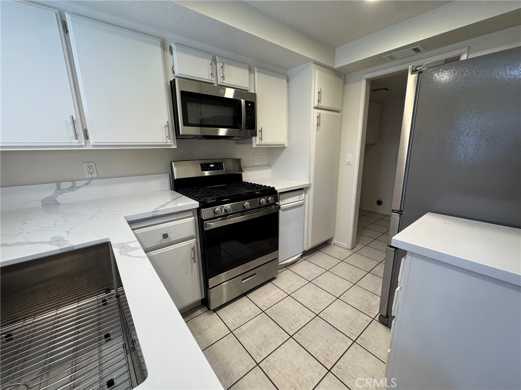 1254 Sand Creek Road San Dimas, CA 91773 - Photo 9 of 26 a kitchen with a sink and a stove top oven