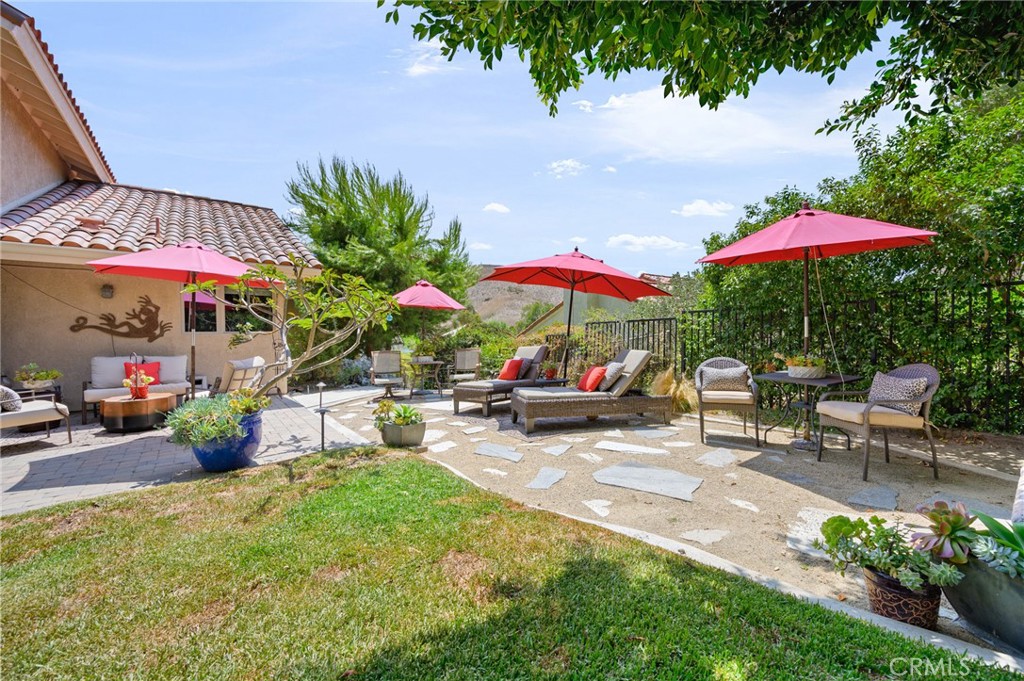28111 Via Rueda San Juan Capistrano, CA 92675 - Photo 22 of 30 a view of a patio with a table and chairs under an umbrella