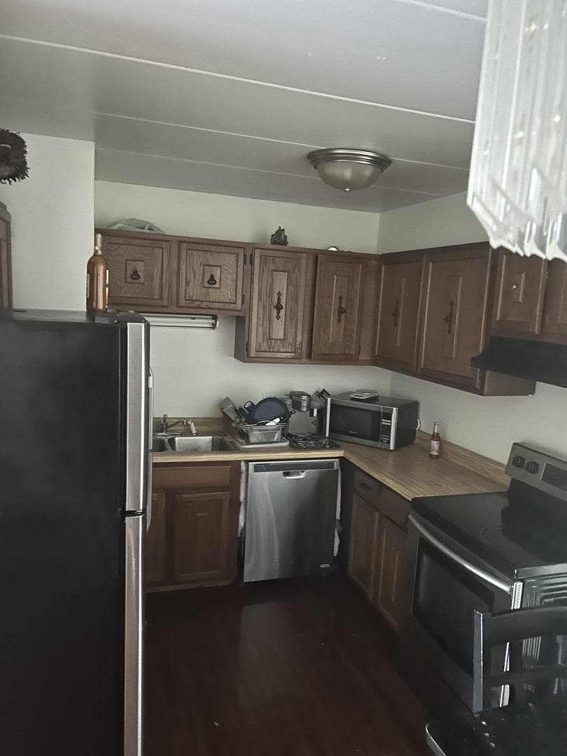 17006 Novak Drive, Unit 102 Hazel Crest, IL 60429 - Photo 4 of 6 a kitchen with stainless steel appliances granite countertop a sink stove and refrigerator