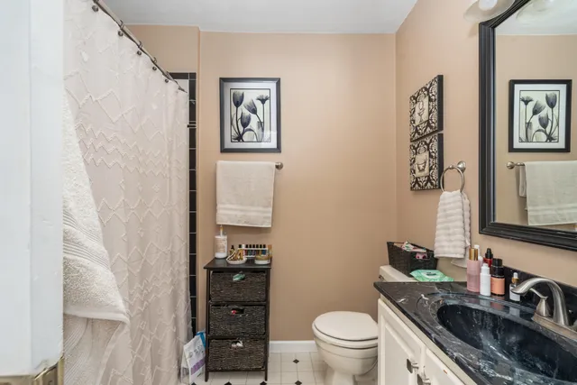 a bathroom with a toilet a sink and mirror