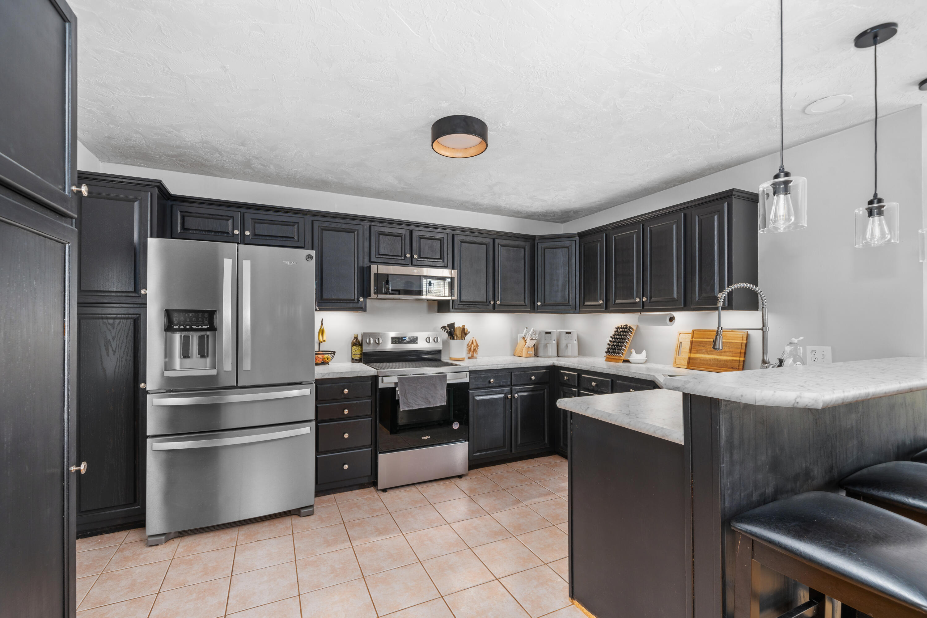 191 Pin Oak Drive Blue Ridge, VA 24064 - Photo 8 of 26 a kitchen with stainless steel appliances a stove a sink a refrigerator and cabinets