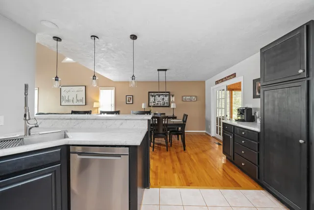 a kitchen with stainless steel appliances granite countertop sink stove top oven and cabinets