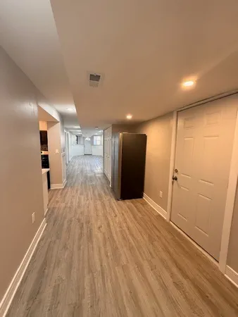 a view of empty room with wooden floor