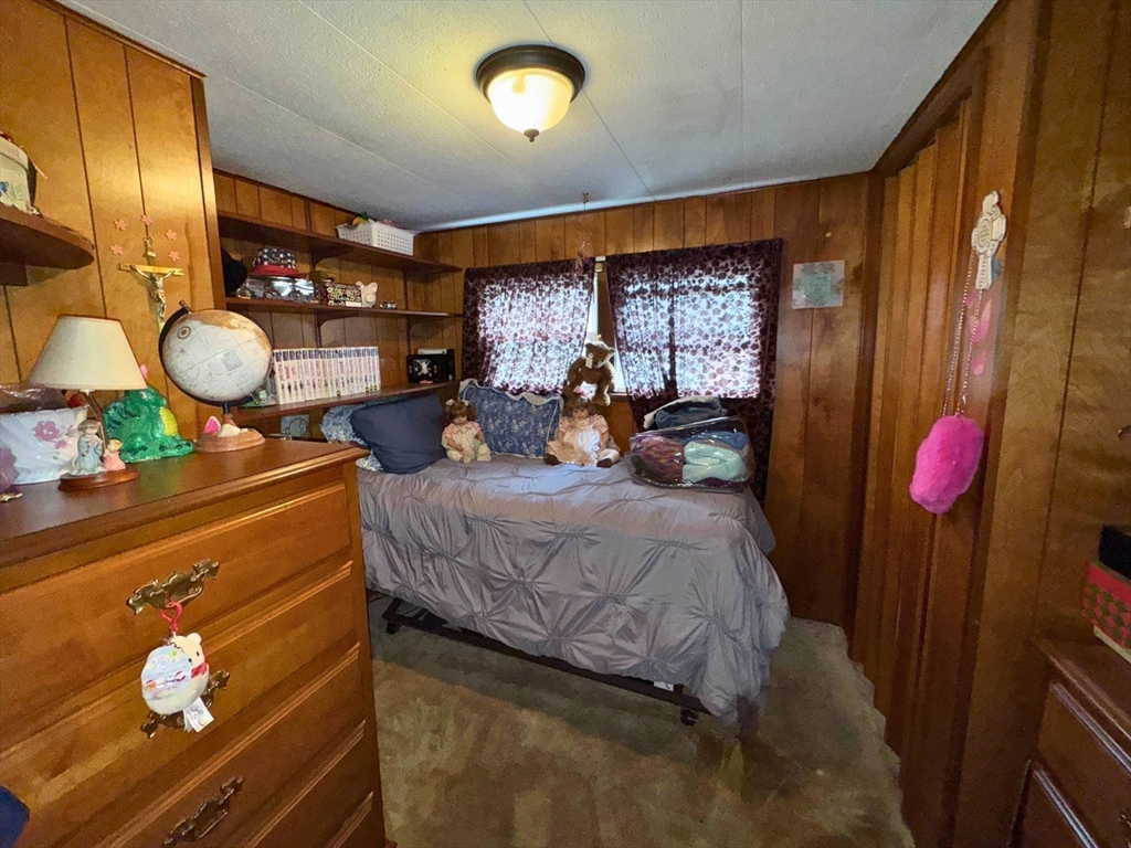 7 Oriole Drive Chicopee, MA 01020 - Photo 7 of 9 a bedroom with a bed and wooden floor