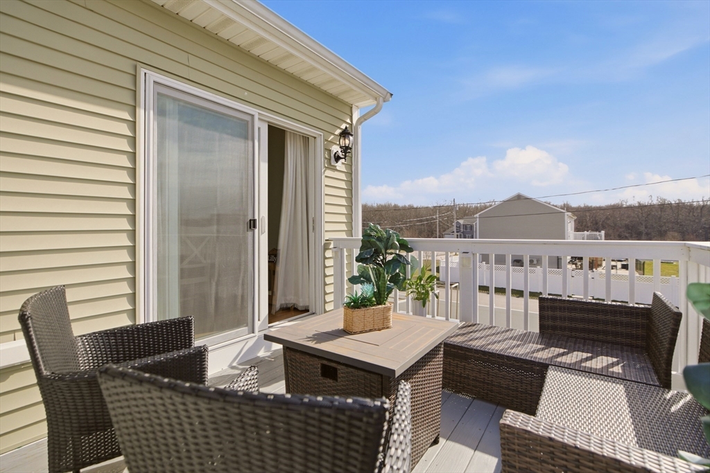 341 Courtney Street Fall River, MA 02720 - Photo 3 of 39 a balcony with furniture and a potted plant
