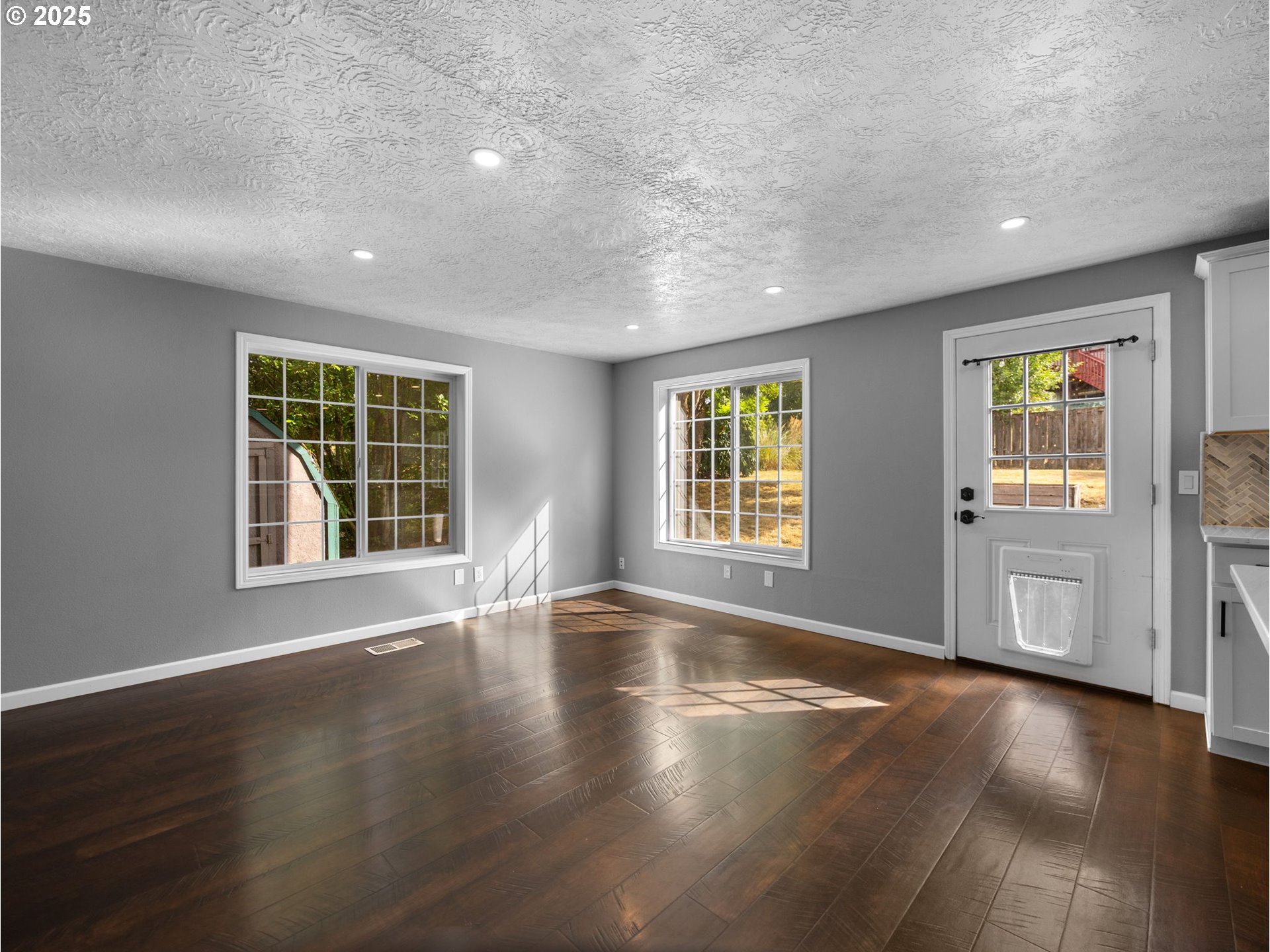 2510 Southwest Lillyben Court Gresham, OR 97080 - Photo 11 of 26 a view of an empty room with a window and wooden floor
