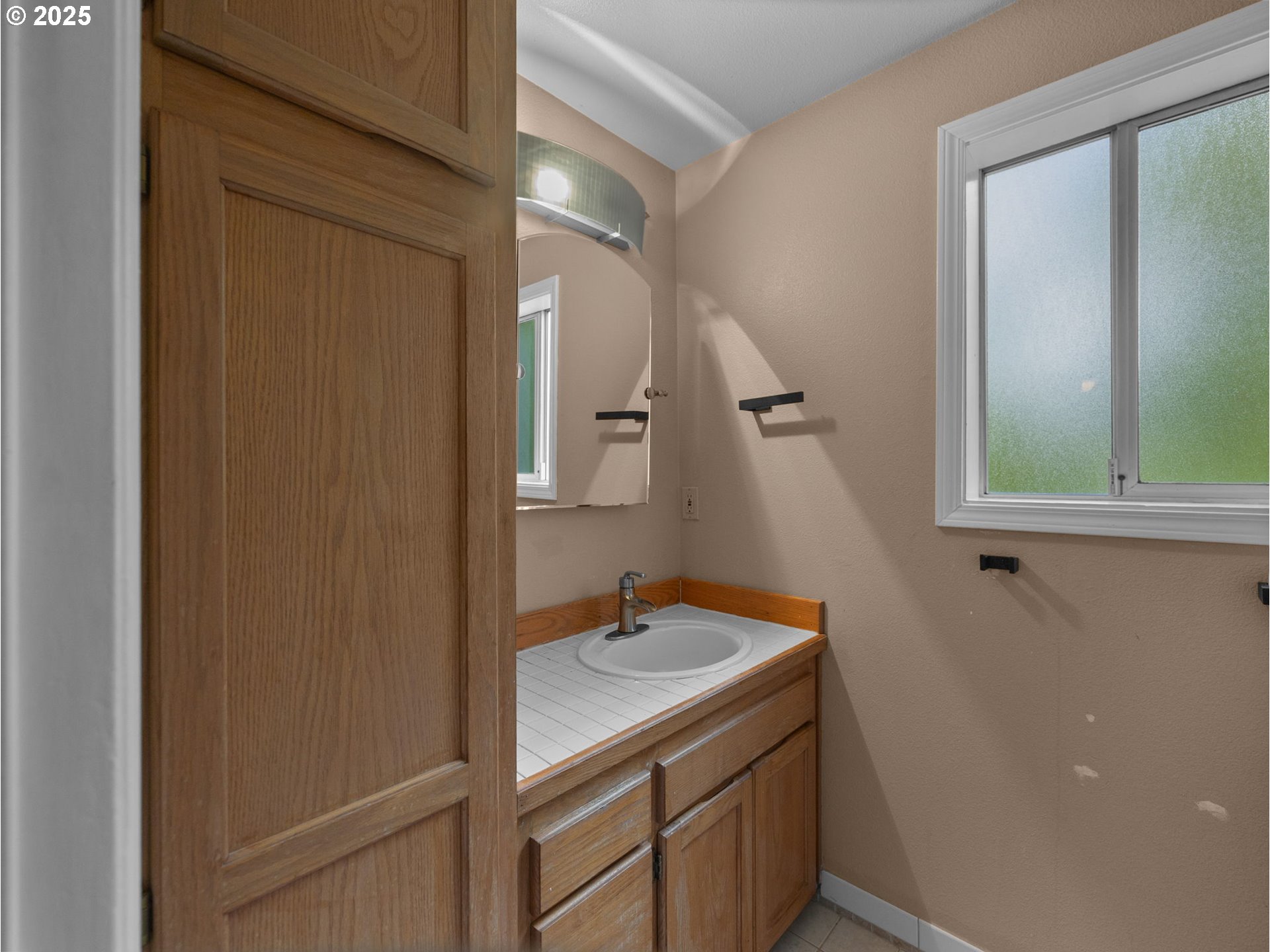 2510 Southwest Lillyben Court Gresham, OR 97080 - Photo 15 of 26 a bathroom with a sink and a mirror