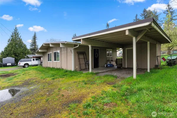 a view of a house with backyard porch and furniture