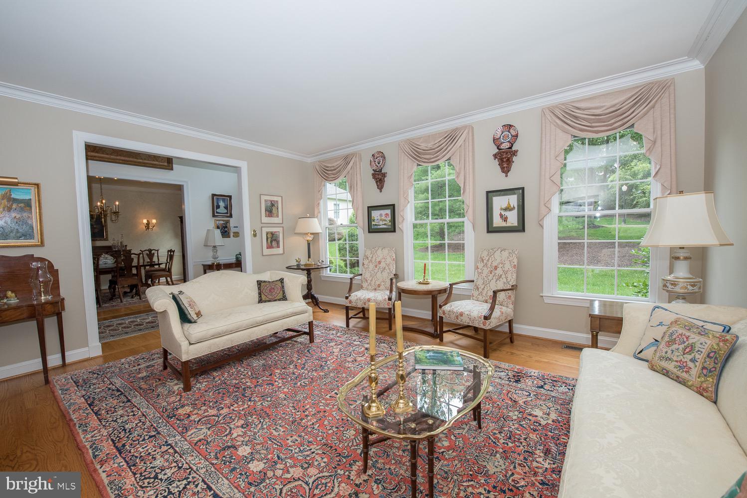 201 3 Rivers Court, Unit 101 Berwyn, PA 19312 - Photo 5 of 30 Formal living room with 3 large windows