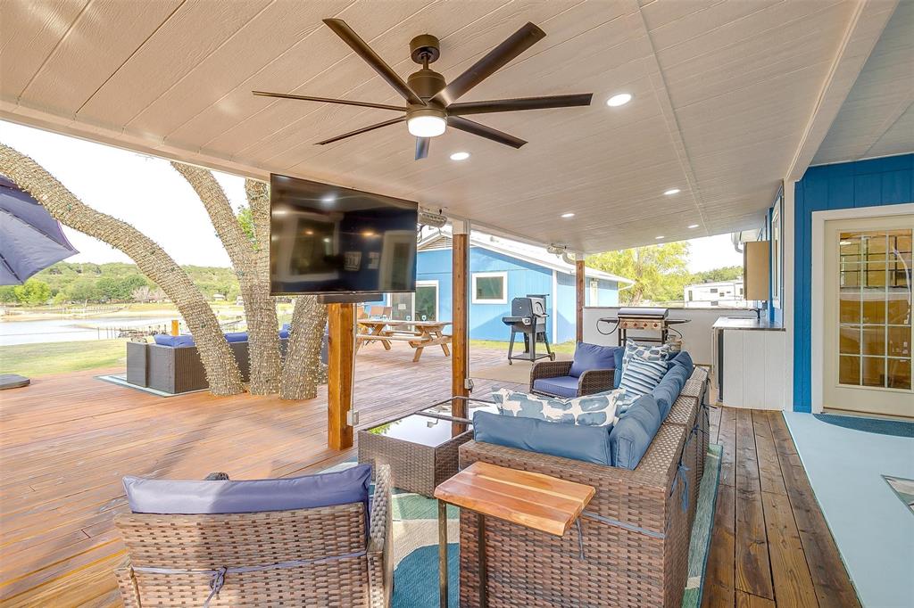 520 Deer Trail Gordon, TX 76453 - Photo 31 of 40 Wooden terrace with outdoor lounge area, a ceiling fan, and a grill