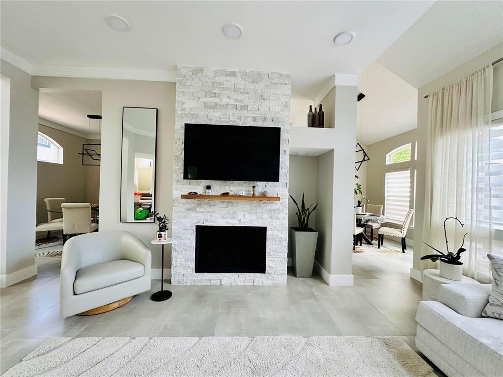784 South Pennsylvania Avenue Winter Park, FL 32789 - Photo 6 of 29 a living room with furniture a fireplace and a flat screen tv