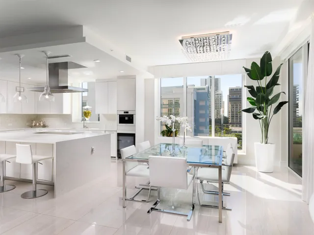a kitchen with a table chairs refrigerator and cabinets