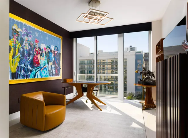 a living room with furniture and a floor to ceiling window