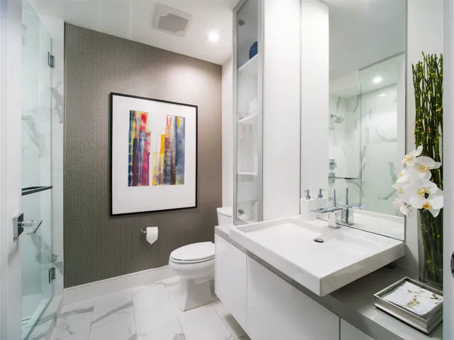 a bathroom with a sink mirror and toilet