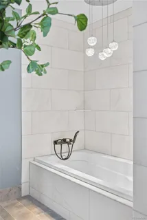 a bathroom with a bathtub and shower