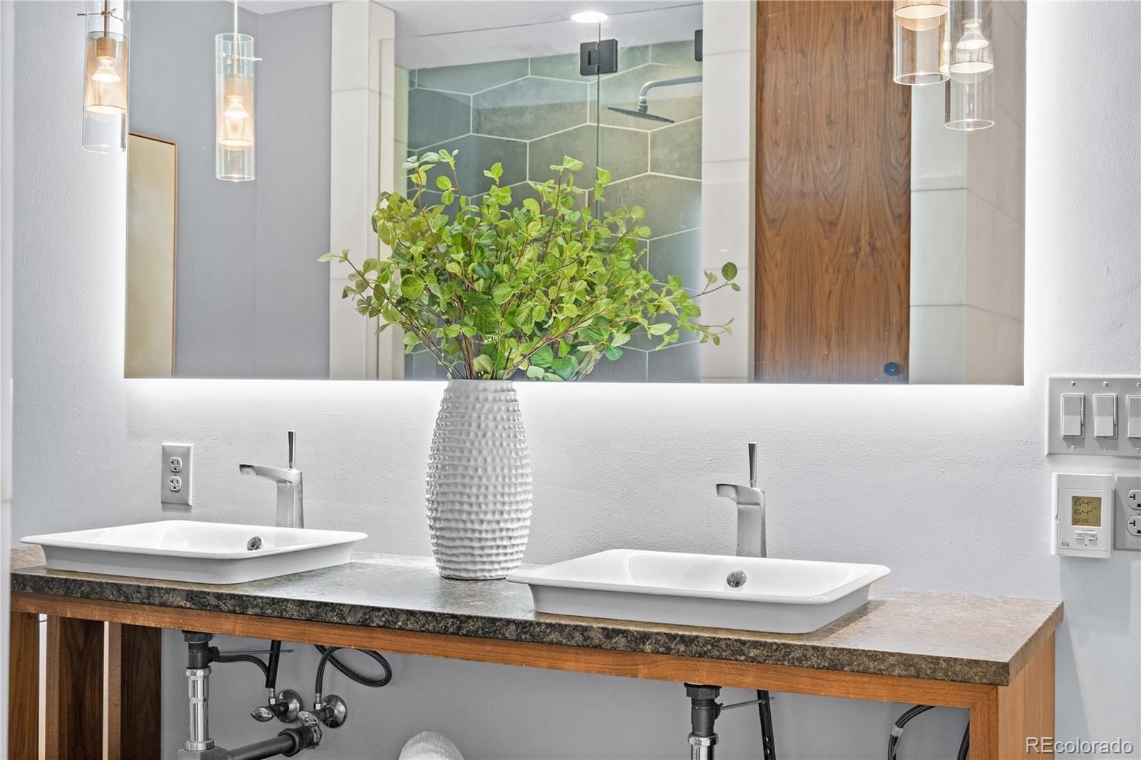 1630 North Clarkson Street, Unit 110 Denver, CO 80218 - Photo 12 of 36 a bathroom with a sink and a mirror