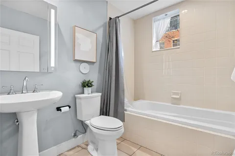 a bathroom with a sink mirror toilet and bathtub