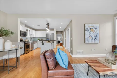 a living room with stainless steel appliances kitchen island granite countertop furniture and a kitchen view