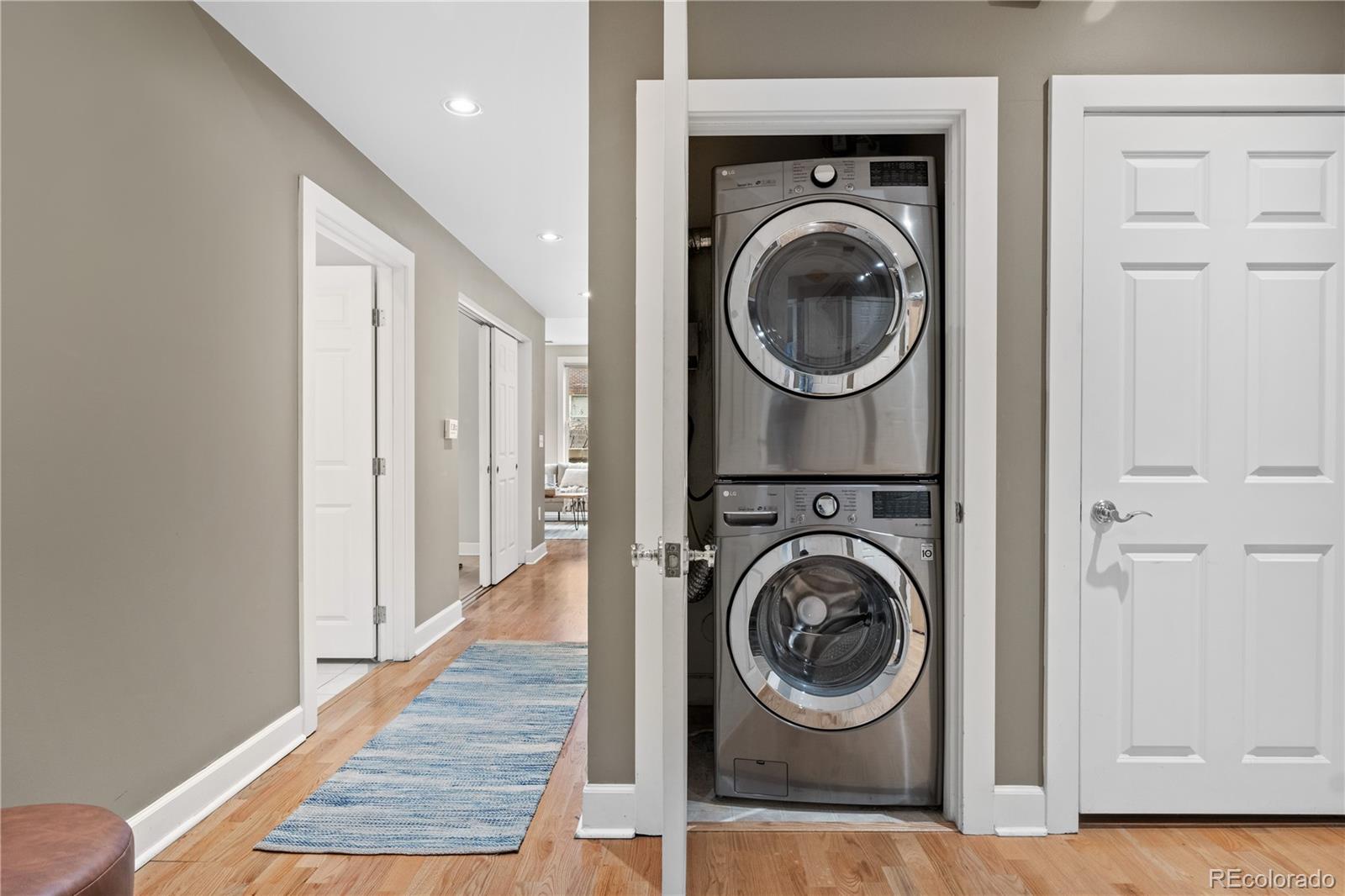 1630 North Clarkson Street, Unit 110 Denver, CO 80218 - Photo 35 of 36 a view of a hallway with washer and dryer