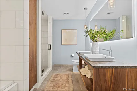 a bathroom with a sink a mirror and a shower