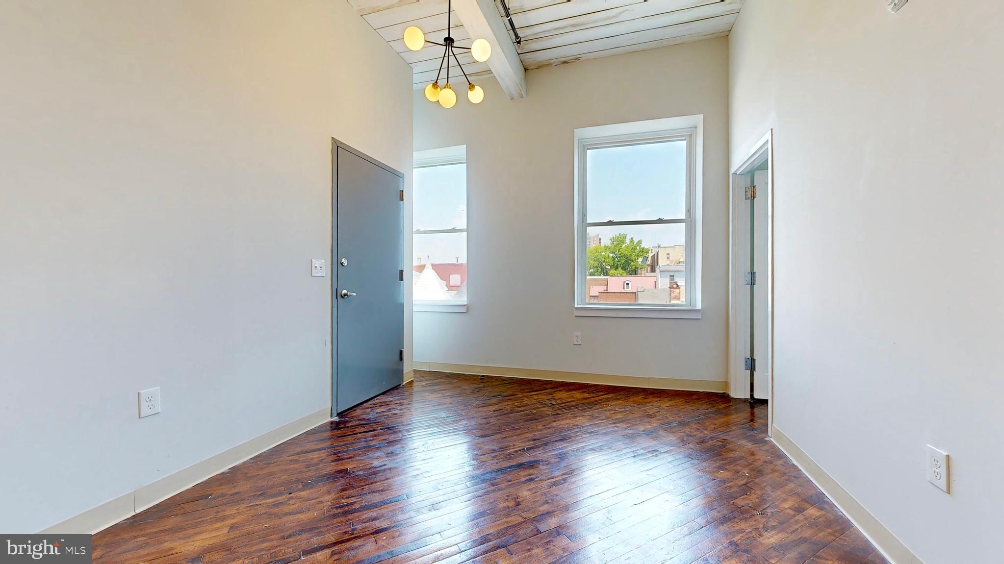 100 South 4th Street, Unit 301 Reading, PA 19602 - Photo 13 of 21 an empty room with wooden floor windows and entrance