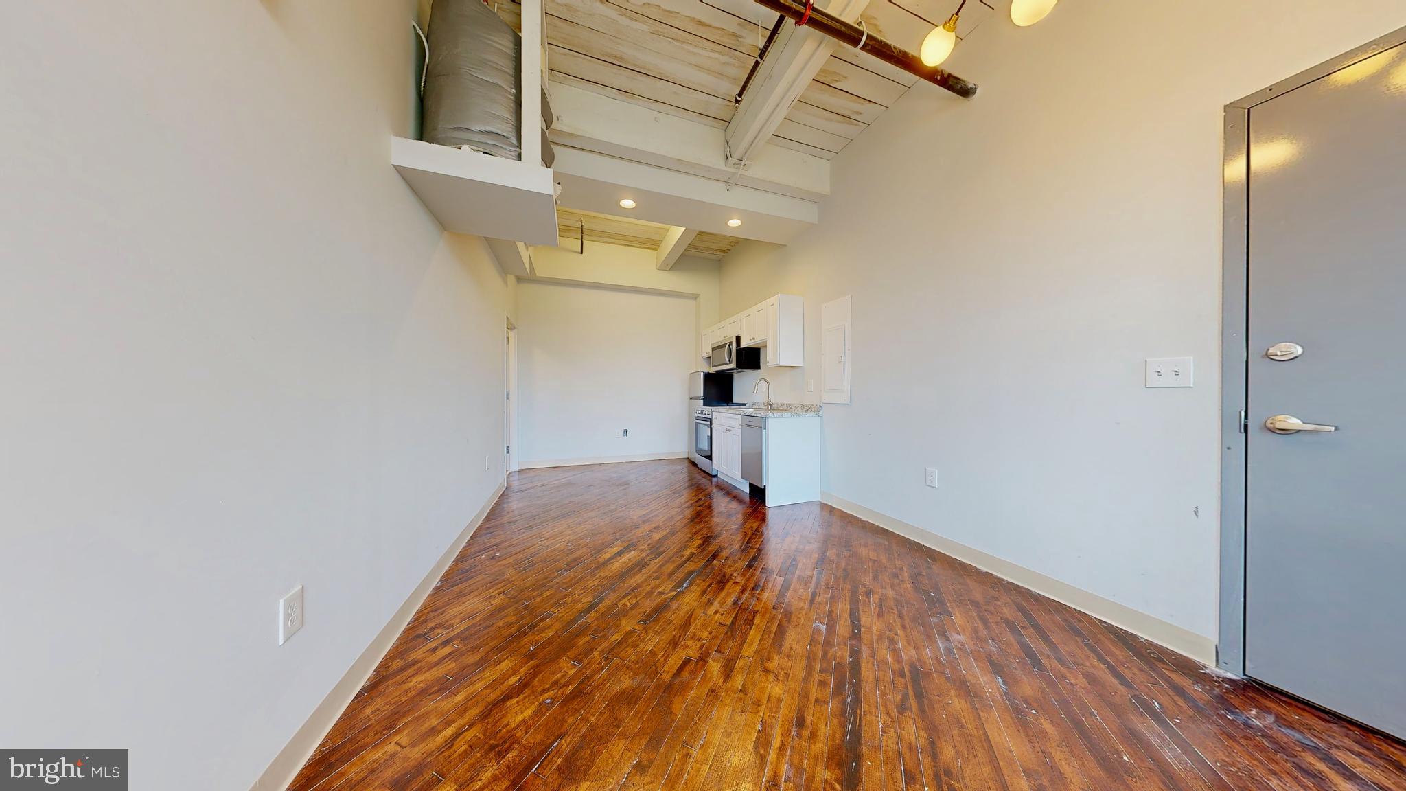 100 South 4th Street, Unit 301 Reading, PA 19602 - Photo 14 of 21 a view of a room with wooden floor and a ceiling fan