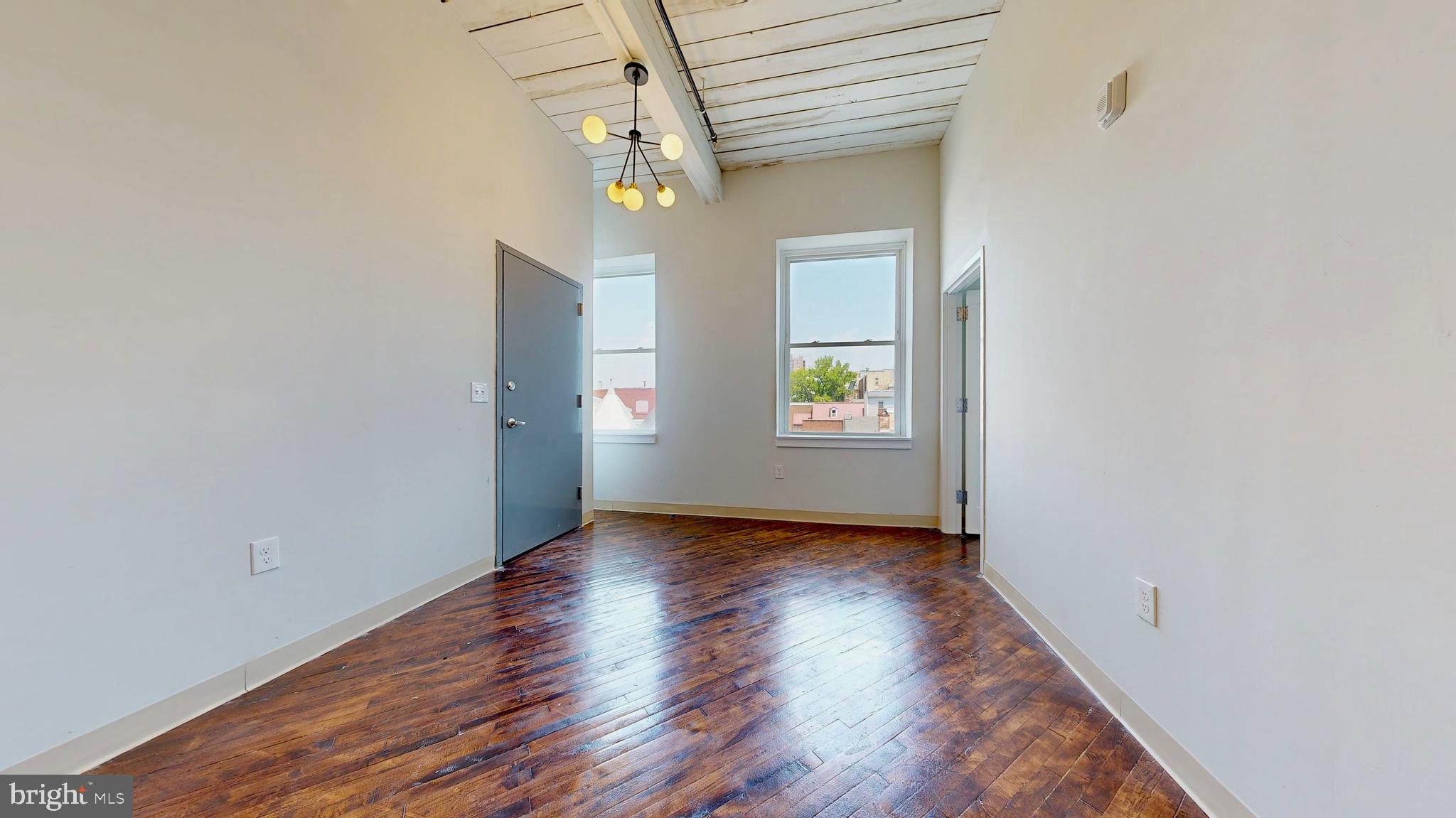 100 South 4th Street, Unit 301 Reading, PA 19602 - Photo 17 of 21 an empty room with window and wooden floor