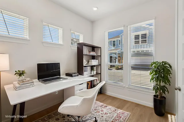 a work room with furniture lamp and window