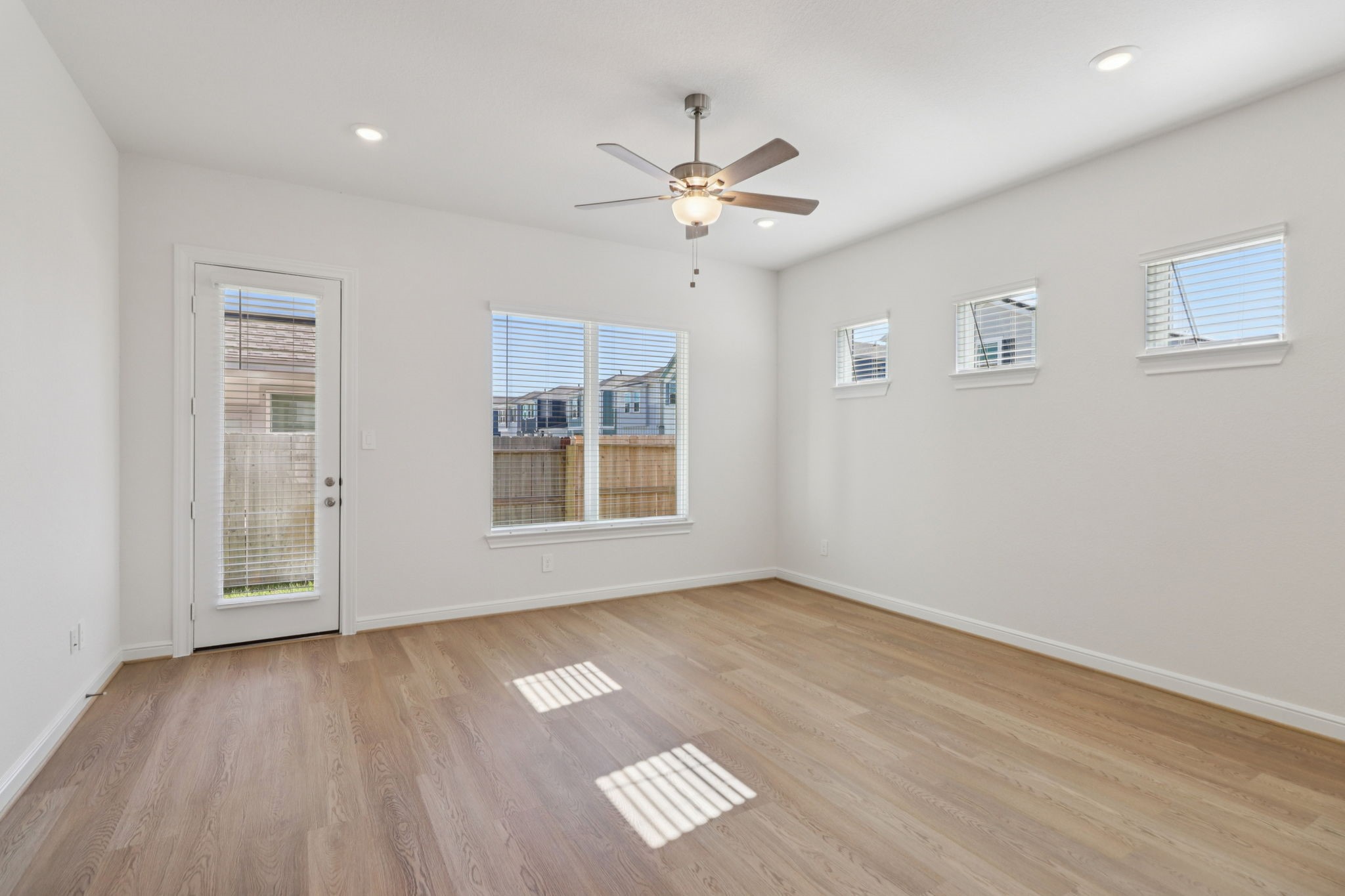 708 Topwater Trail Kemah, TX 77565 - Photo 2 of 43 a view of an empty room with a window and wooden floor