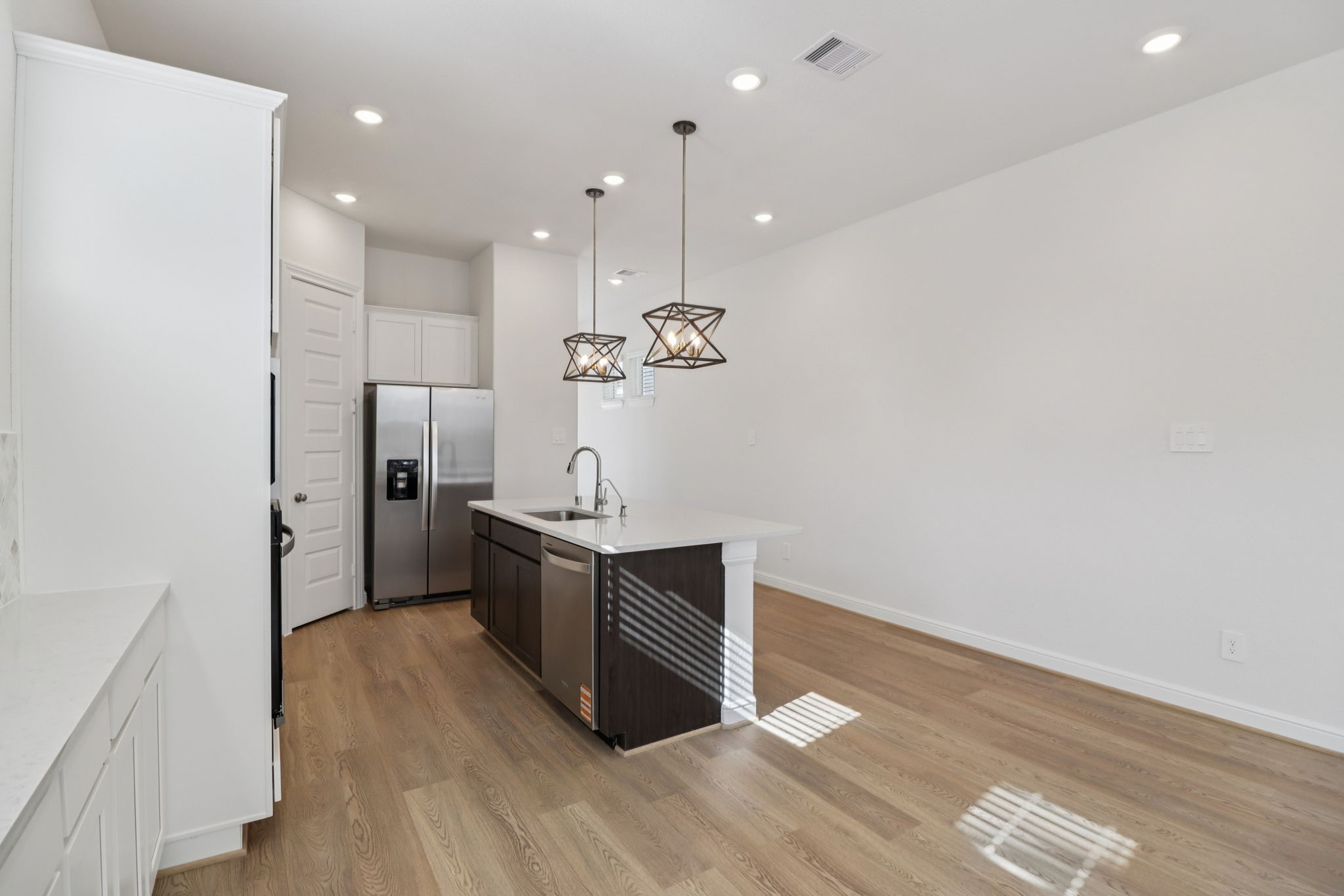 708 Topwater Trail Kemah, TX 77565 - Photo 9 of 43 a kitchen with stainless steel appliances a refrigerator and a wooden floor