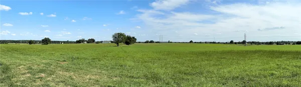 a view of a golf course with a building in the background