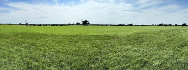 an aerial view of a houses with a yard