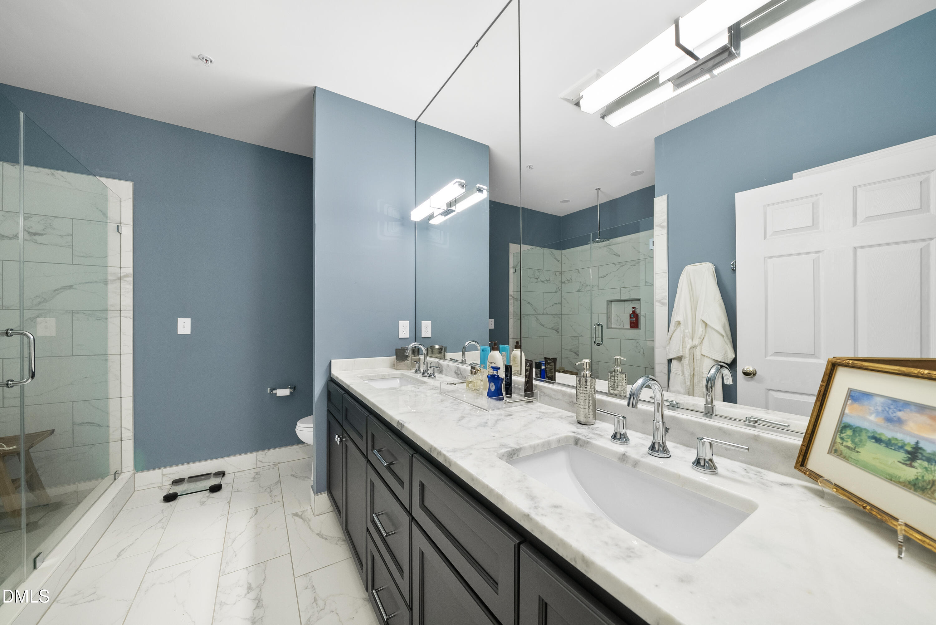 200 South Dawson Street, Unit 306 Raleigh, NC 27601 - Photo 18 of 24 a bathroom with sinks double vanity and a mirror