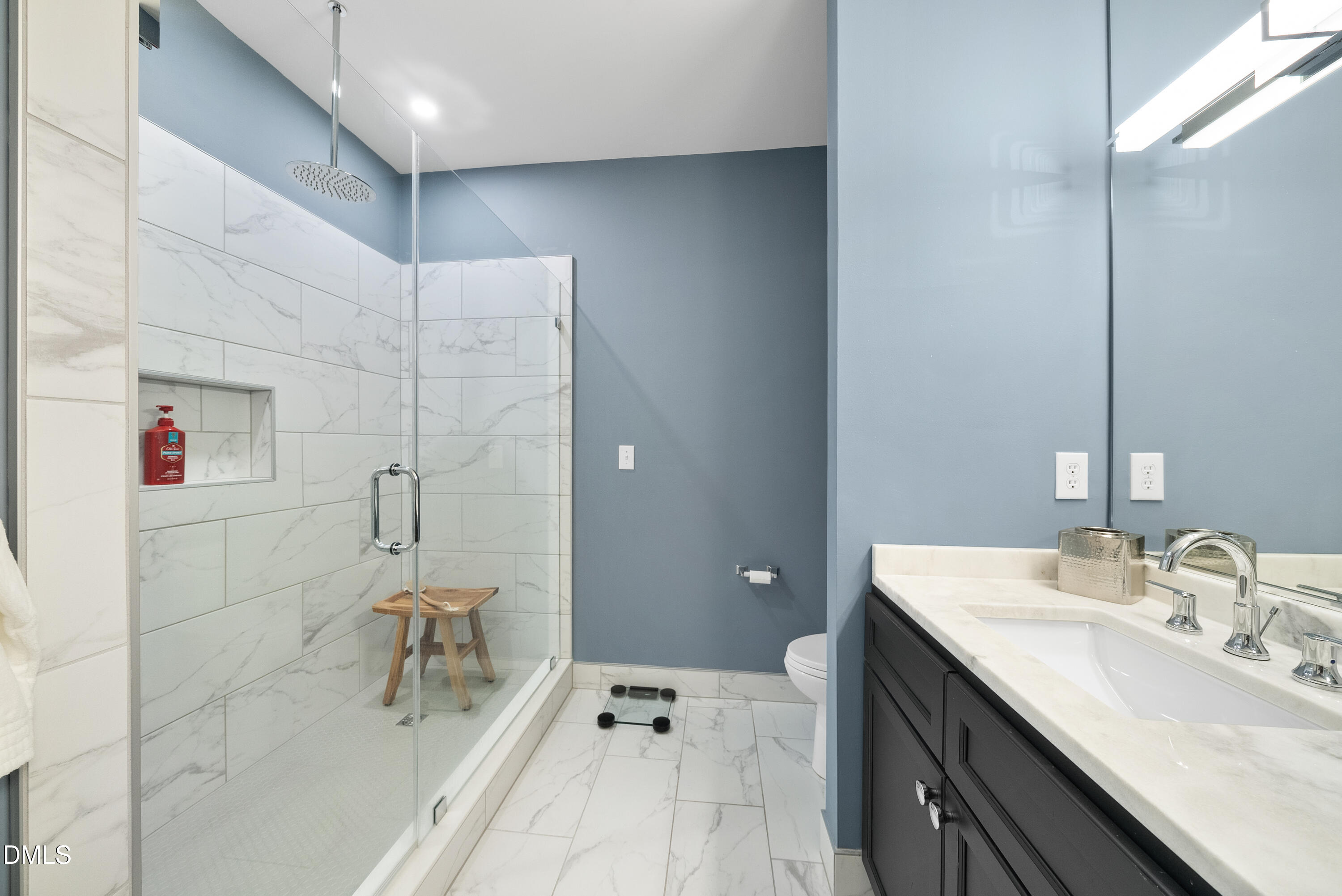 200 South Dawson Street, Unit 306 Raleigh, NC 27601 - Photo 19 of 24 a en suite bathroom with a double vanity sink a mirror and a shower