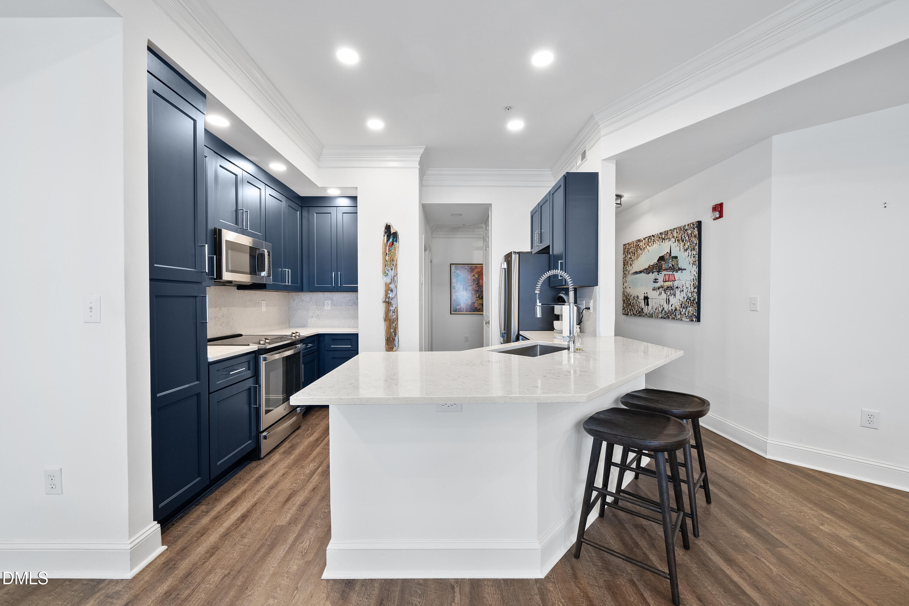 200 South Dawson Street, Unit 306 Raleigh, NC 27601 - Photo 7 of 24 a kitchen with stainless steel appliances kitchen island granite countertop a refrigerator and a stove top oven