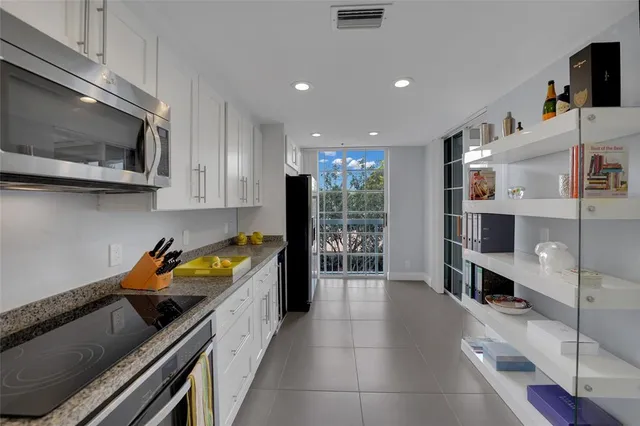 a kitchen with stainless steel appliances refrigerator and cabinets
