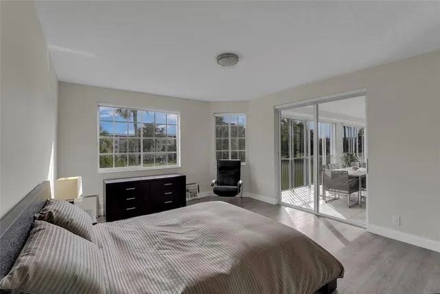a living room with furniture and floor to ceiling windows