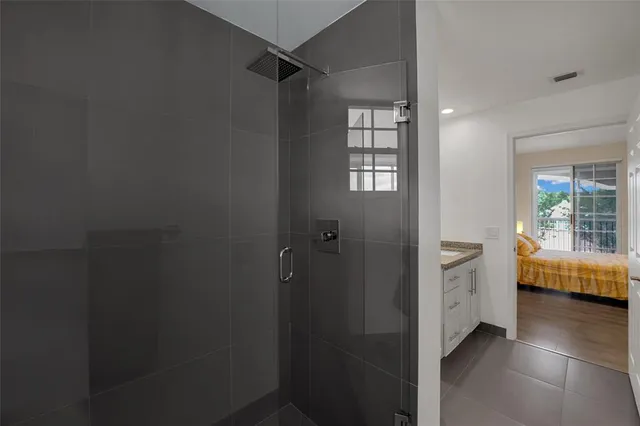 a bathroom with a granite countertop sink mirror vanity and toilet