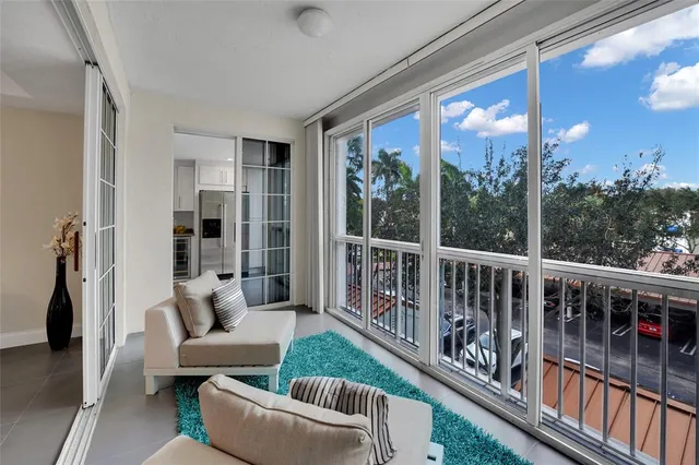 a view of a livingroom with wooden floor and floor to ceiling window