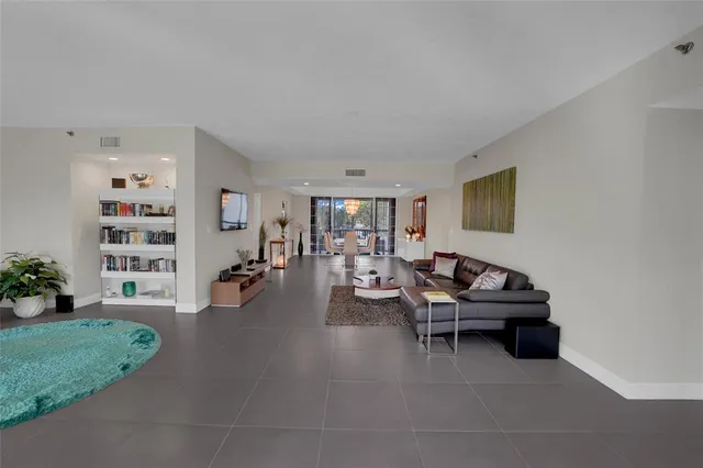a living room with furniture and a bookshelf