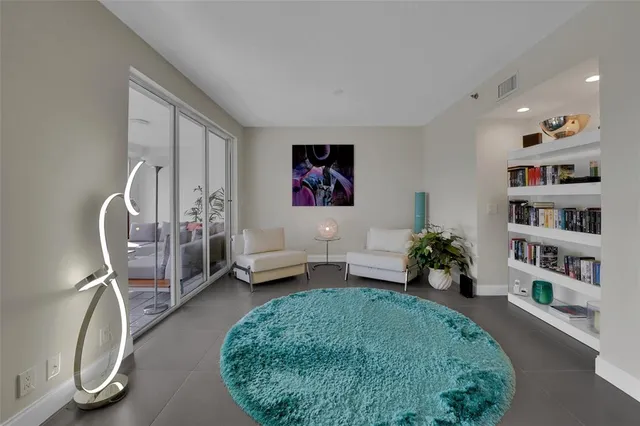 a living room with furniture a table and chairs